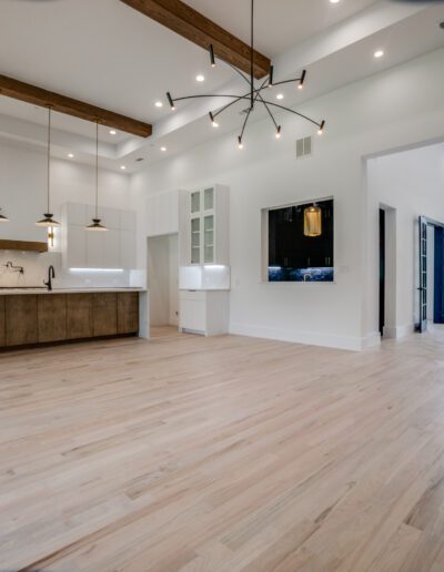 Spacious modern kitchen with wooden accents and pendant lighting.